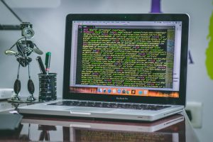 a laptop with computer coding system on the table