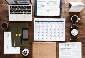 a laptop and a calendar on the table